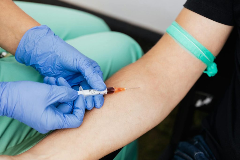 a medical professional extracting blood from a patient
